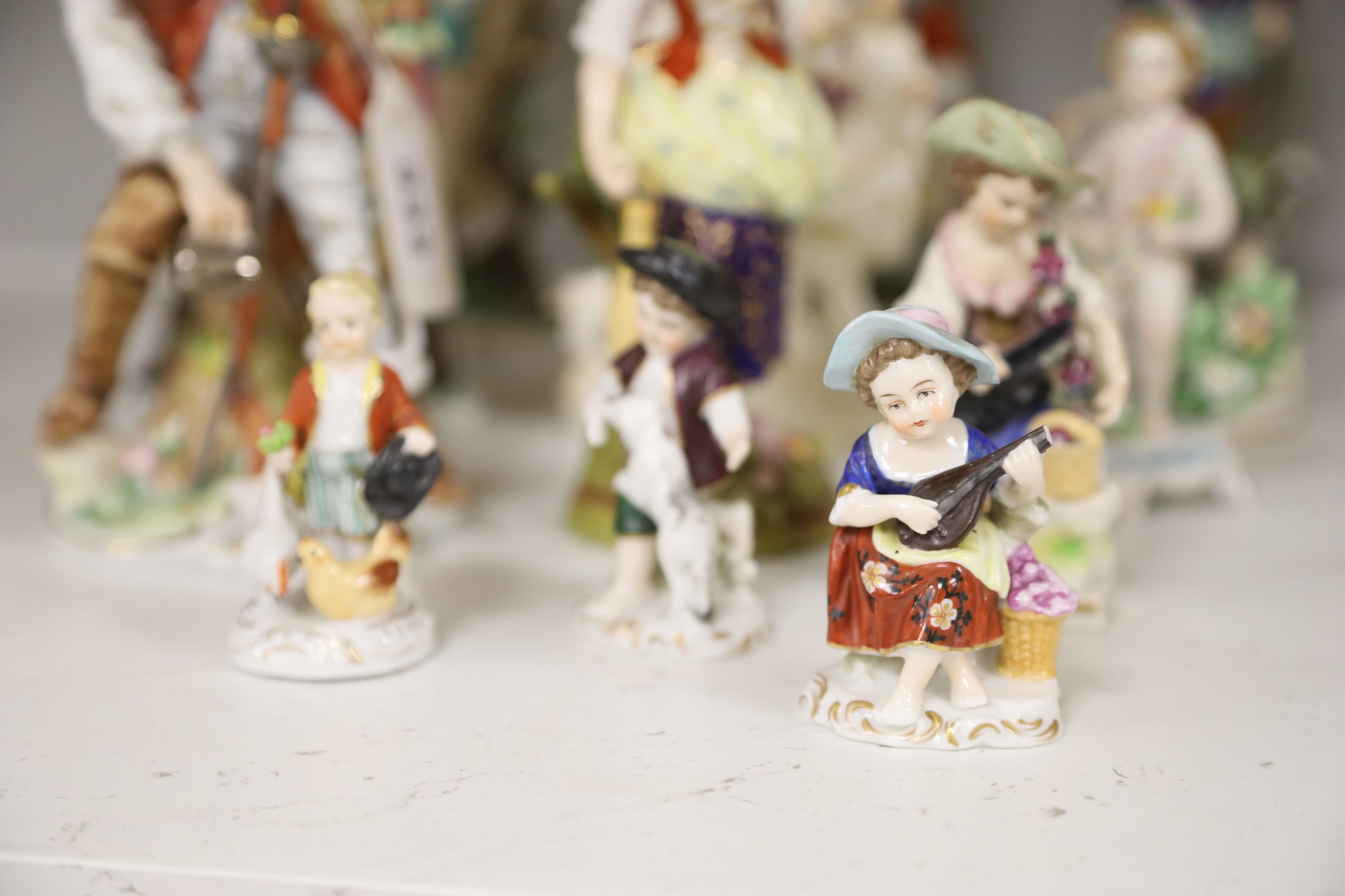 A Derby tailors wife group and twelve Continental or Staffs porcelain figures, tallest 20cm